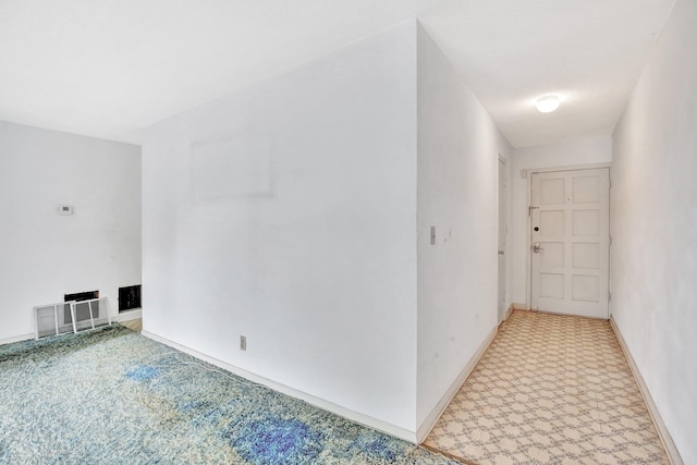 interior space with carpet flooring and baseboards