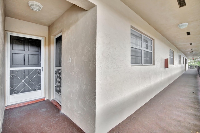 entrance to property with stucco siding