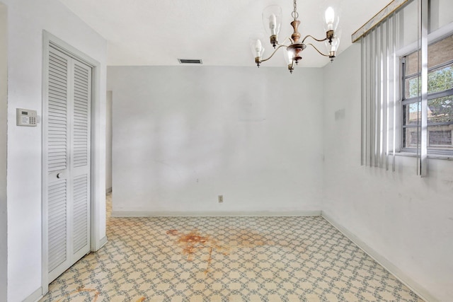 unfurnished dining area featuring light floors, visible vents, a chandelier, and baseboards