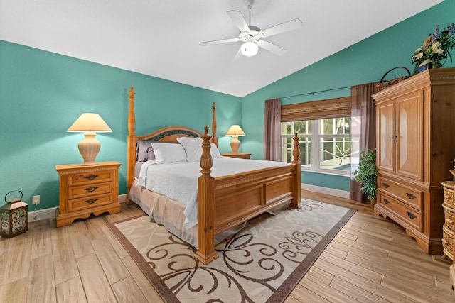 bedroom featuring lofted ceiling, baseboards, ceiling fan, and light wood finished floors