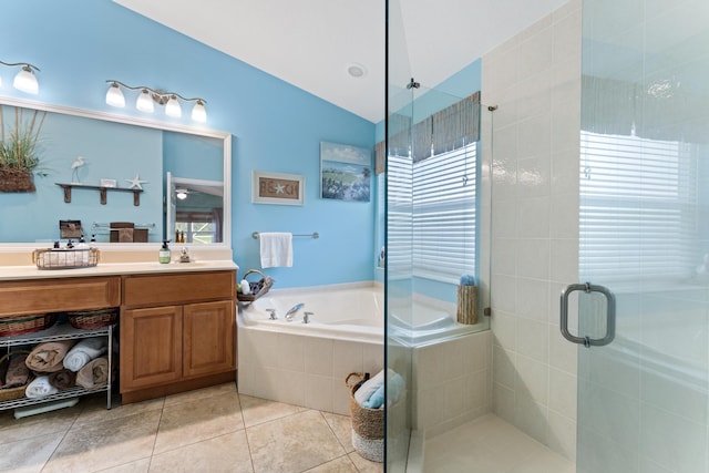 full bathroom with tile patterned flooring, a garden tub, vanity, vaulted ceiling, and a stall shower