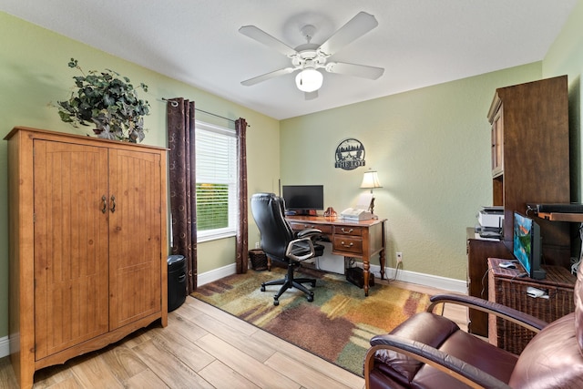 office area featuring light wood-style floors, ceiling fan, and baseboards