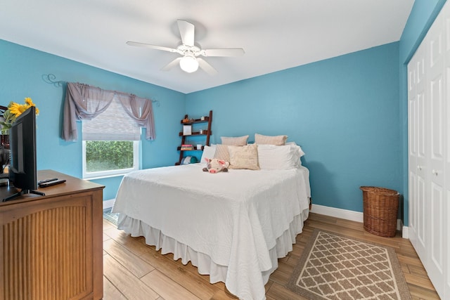 bedroom featuring light wood-type flooring, a closet, and baseboards