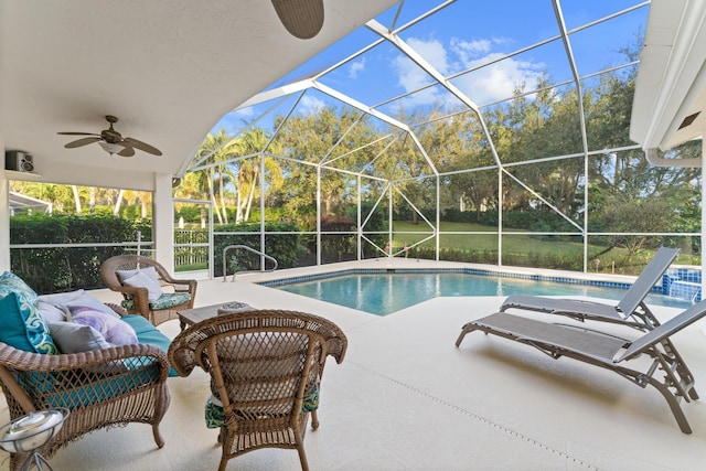 pool featuring a lanai, a patio area, and ceiling fan