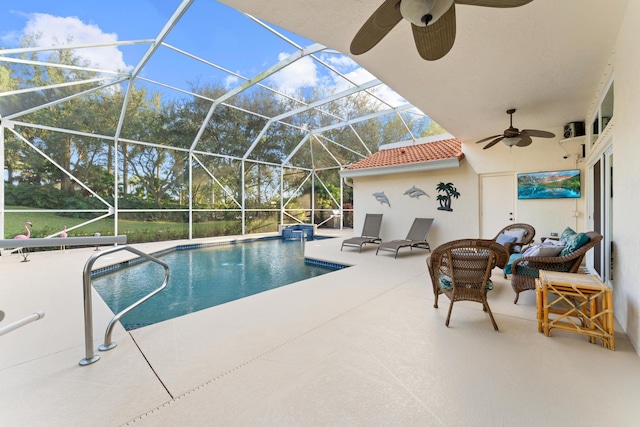 pool with a lanai, a patio area, and ceiling fan