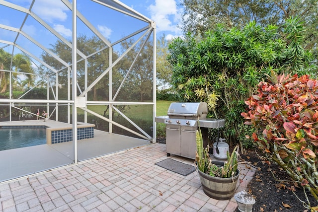 view of patio / terrace with a lanai, a grill, and an outdoor pool