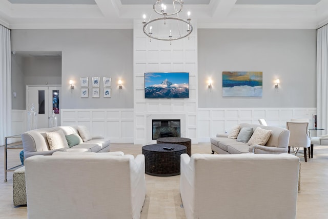 living area with a large fireplace, coffered ceiling, and beam ceiling