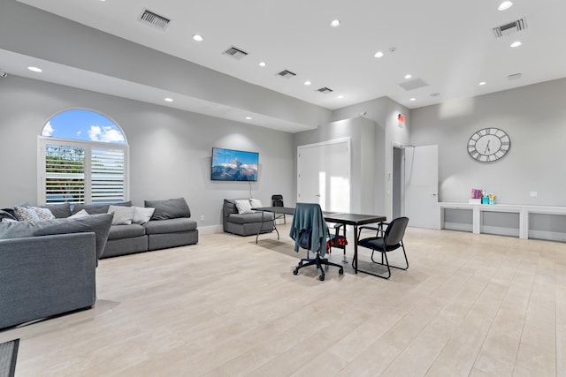 living room featuring light wood-type flooring and visible vents