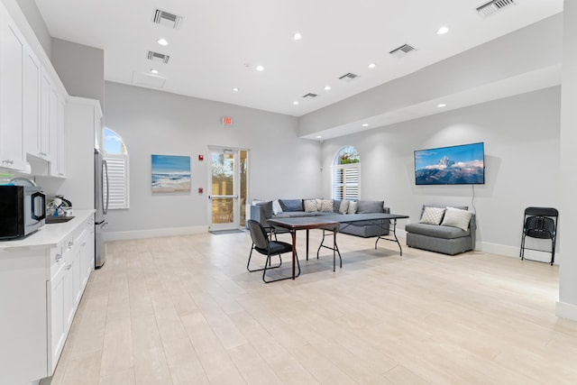 living area with recessed lighting, visible vents, and light wood finished floors