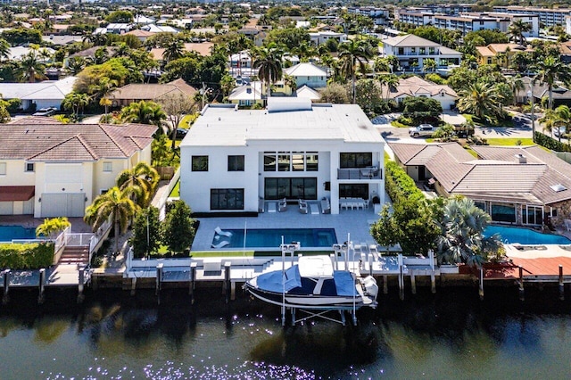 drone / aerial view with a water view and a residential view