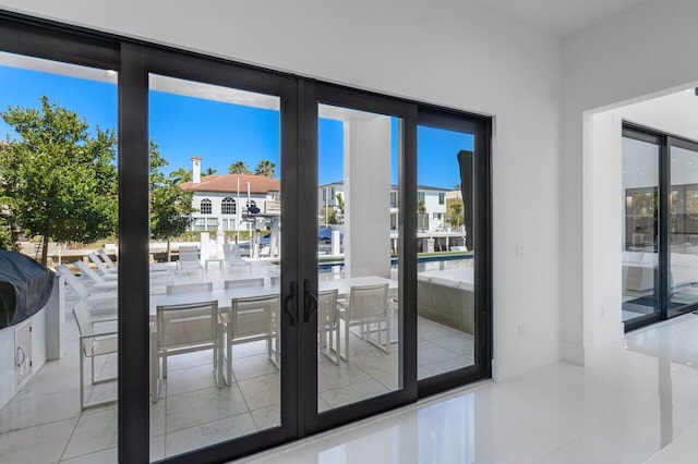 doorway featuring french doors and light tile patterned flooring