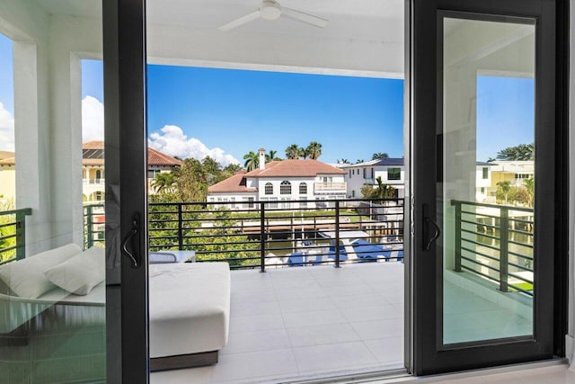 balcony with a residential view and ceiling fan