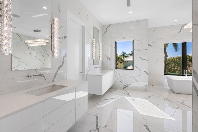 bathroom featuring stone wall, two vanities, a sink, and a healthy amount of sunlight