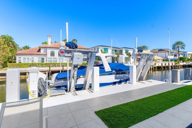 view of jungle gym with a water view, boat lift, a residential view, and a boat dock