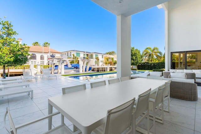 view of patio with outdoor lounge area, a residential view, and an outdoor pool