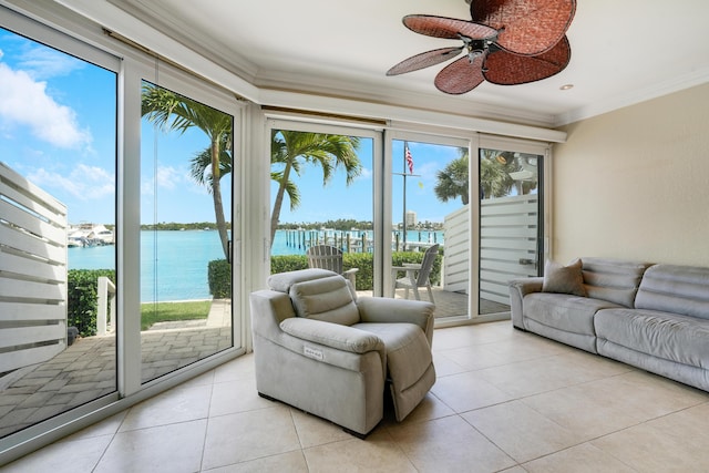 sunroom / solarium featuring a ceiling fan and a water view