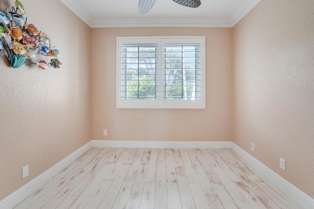 unfurnished room featuring ornamental molding, a textured wall, baseboards, and wood finished floors