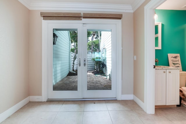 doorway to outside featuring ornamental molding, french doors, light tile patterned flooring, and baseboards