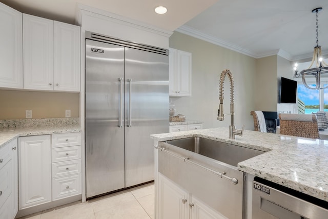 kitchen featuring stainless steel appliances, a sink, white cabinetry, and crown molding