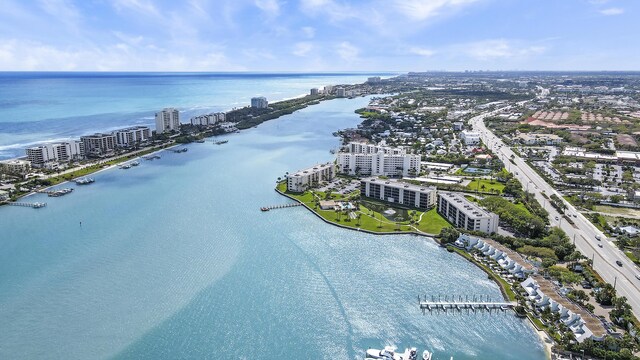 birds eye view of property featuring a water view and a city view