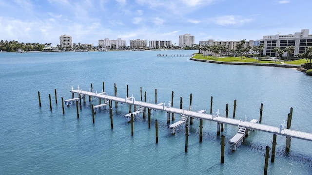 view of dock with a water view and a city view