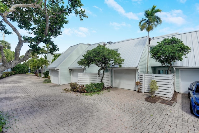 view of front of home featuring metal roof and decorative driveway