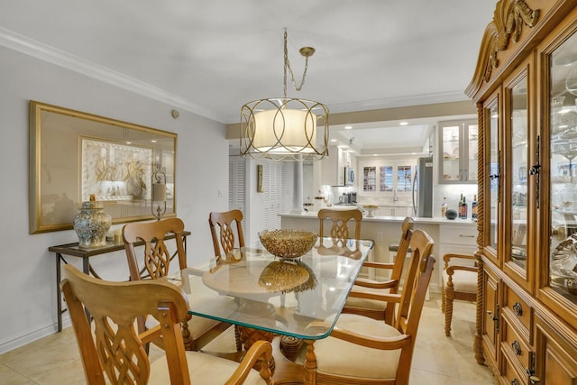 dining space featuring an inviting chandelier, crown molding, and light tile patterned flooring