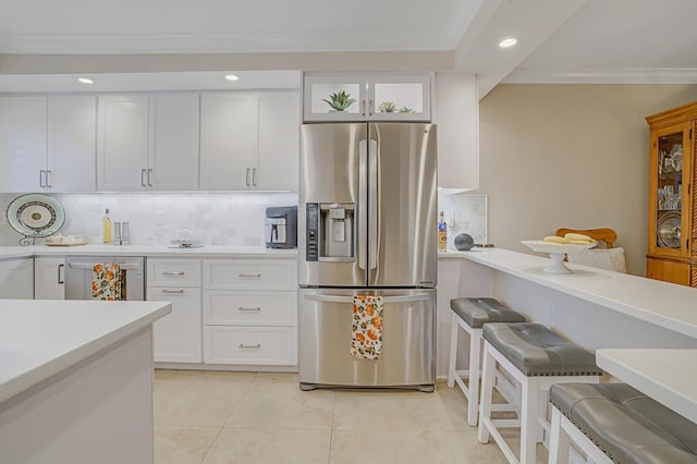 kitchen featuring light tile patterned floors, recessed lighting, stainless steel appliances, white cabinets, and light countertops