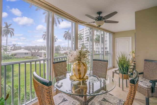 sunroom / solarium with a ceiling fan