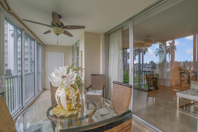 sunroom featuring ceiling fan