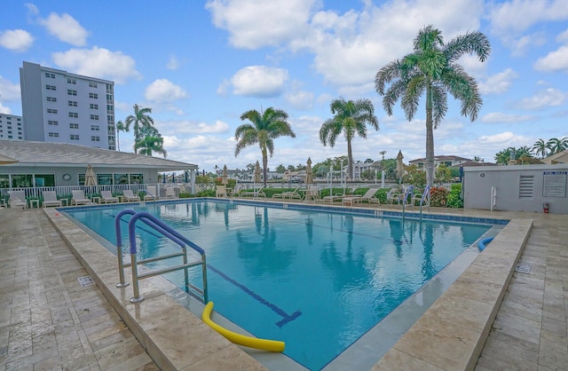 community pool featuring a patio area and fence