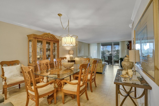 dining space with ornamental molding and light tile patterned flooring