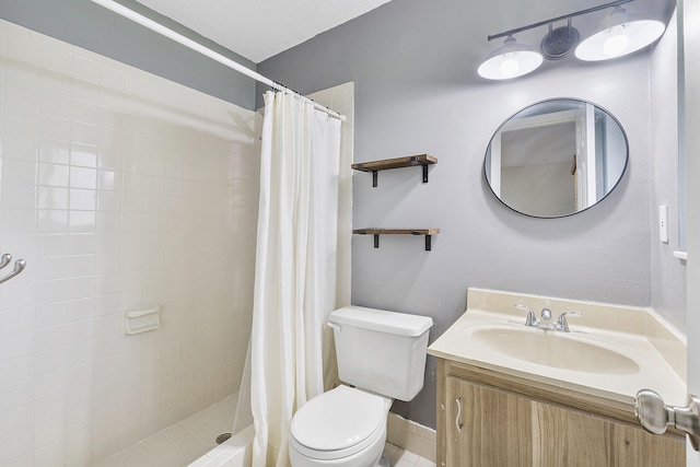 full bathroom featuring vanity, a shower stall, and toilet