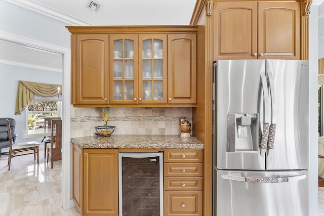kitchen featuring stainless steel fridge with ice dispenser, wine cooler, glass insert cabinets, light stone counters, and crown molding