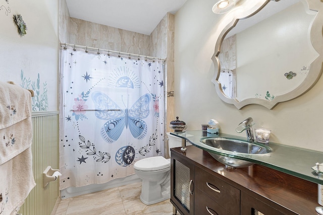 bathroom with toilet, shower / bath combination with curtain, and vanity