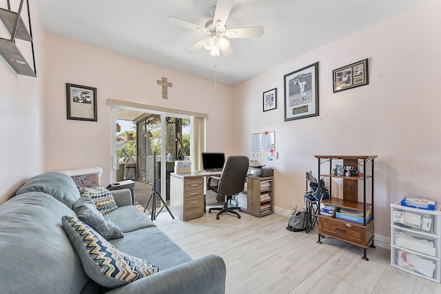 office space with ceiling fan, light wood finished floors, and baseboards