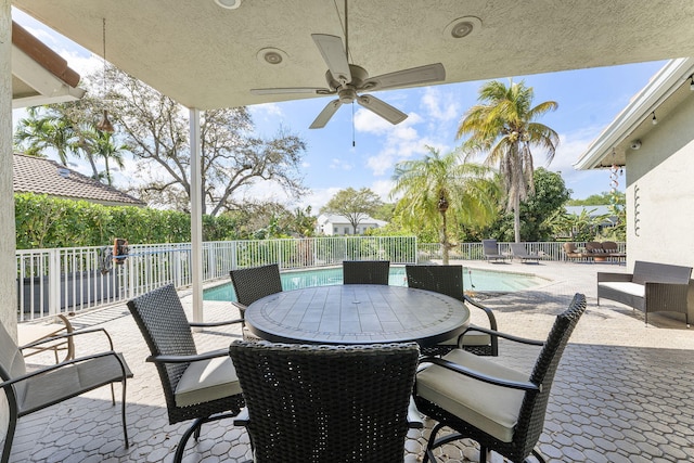 view of patio / terrace featuring ceiling fan, fence, and a fenced in pool