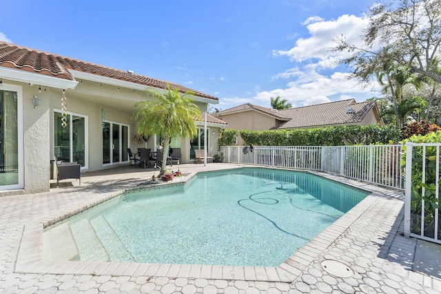 view of pool with a patio area, fence, and a fenced in pool