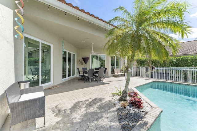 view of pool featuring ceiling fan, fence, a fenced in pool, and a patio