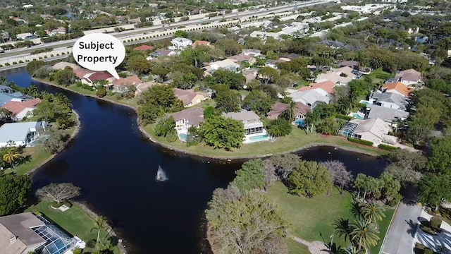 bird's eye view with a water view and a residential view