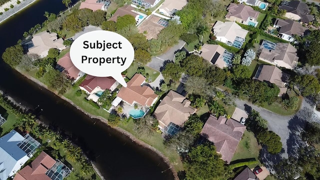 drone / aerial view featuring a residential view and a water view