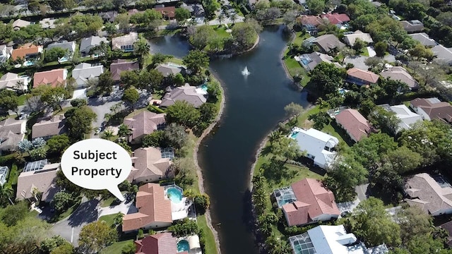 birds eye view of property with a residential view and a water view