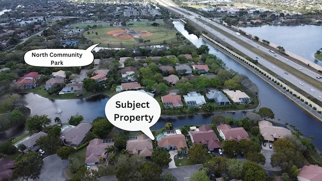 bird's eye view featuring a water view and a residential view