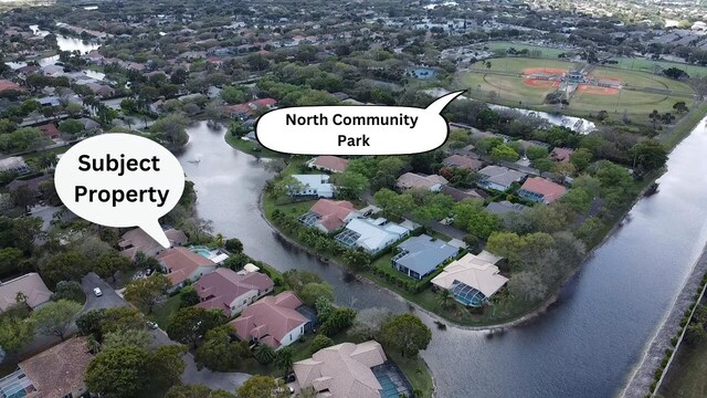 aerial view featuring a water view and a residential view