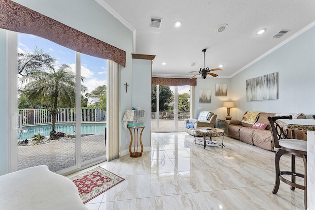 living area featuring ornamental molding, lofted ceiling, and visible vents