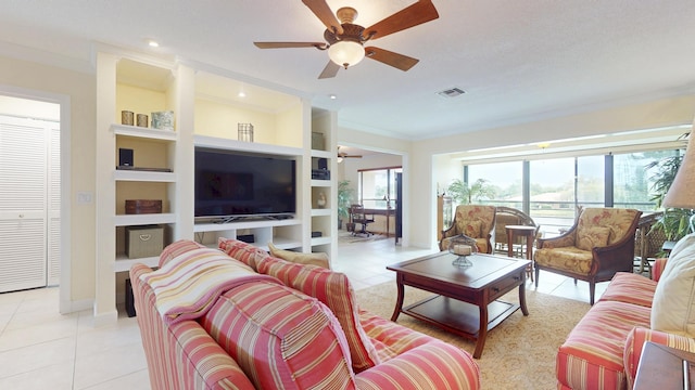 living area with light tile patterned floors, ceiling fan, visible vents, and crown molding