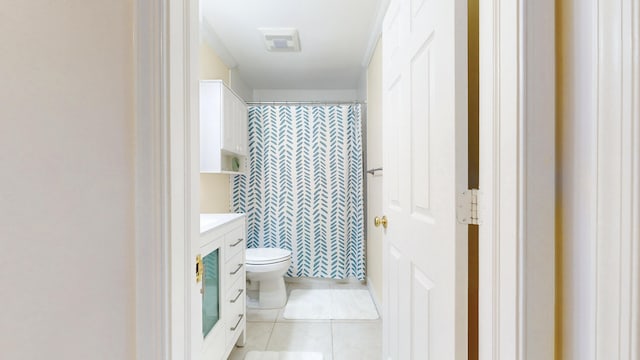 bathroom with visible vents, toilet, vanity, a shower with curtain, and tile patterned floors