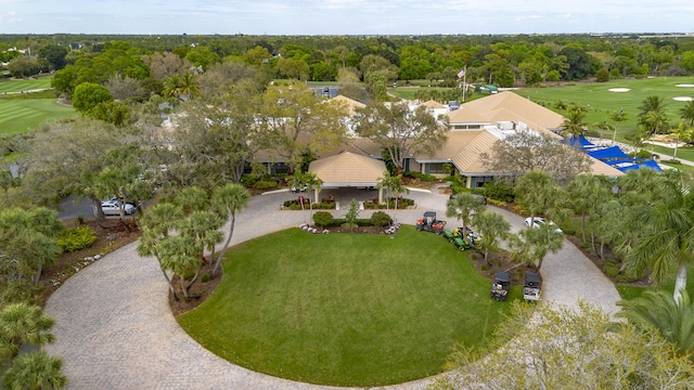 drone / aerial view featuring a view of trees and golf course view