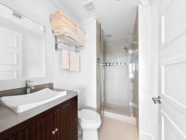 bathroom featuring toilet, vanity, a shower stall, and visible vents