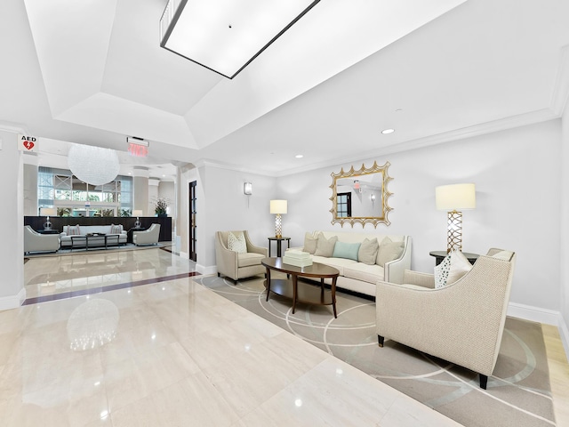 living area featuring a tray ceiling, decorative columns, crown molding, recessed lighting, and baseboards